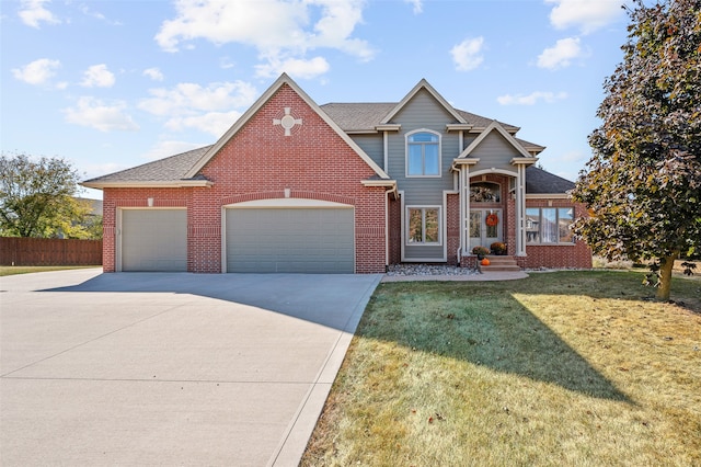 view of front of property with a front yard and a garage