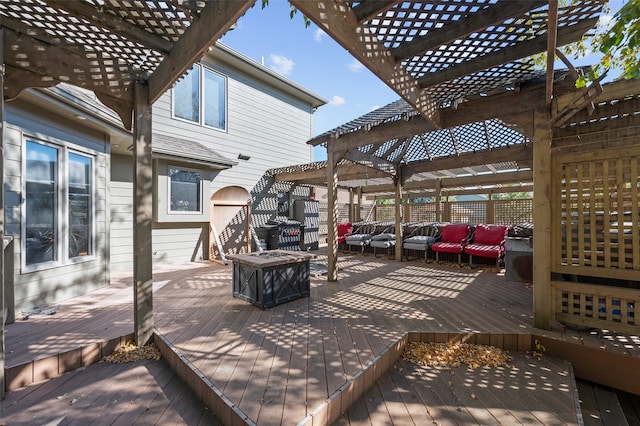 wooden deck featuring an outdoor living space with a fire pit and a pergola