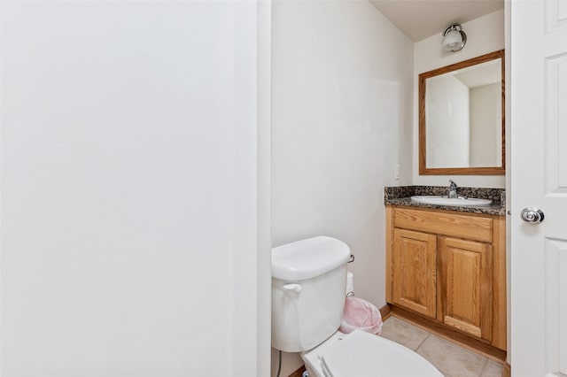 bathroom with vanity, toilet, and tile patterned floors