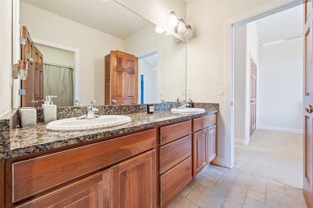 bathroom with walk in shower, vanity, and tile patterned flooring