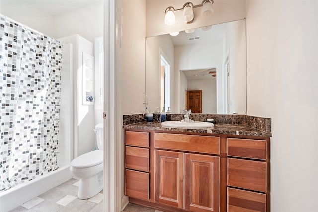 bathroom featuring vanity, toilet, and curtained shower