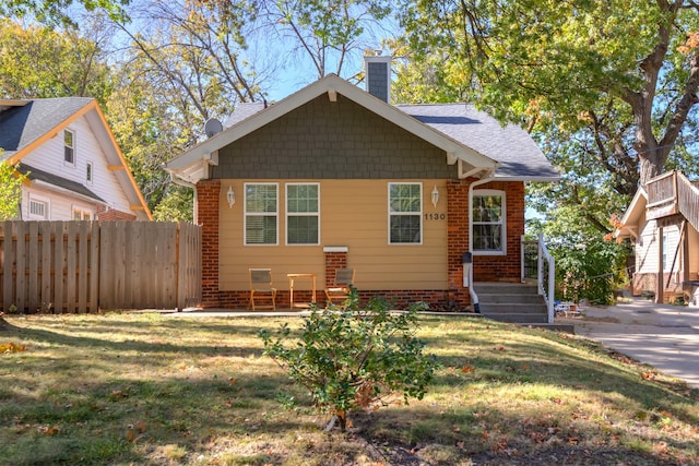 bungalow-style house with a front yard