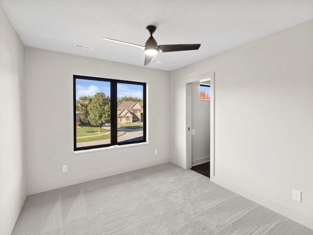 unfurnished room with ceiling fan and light carpet