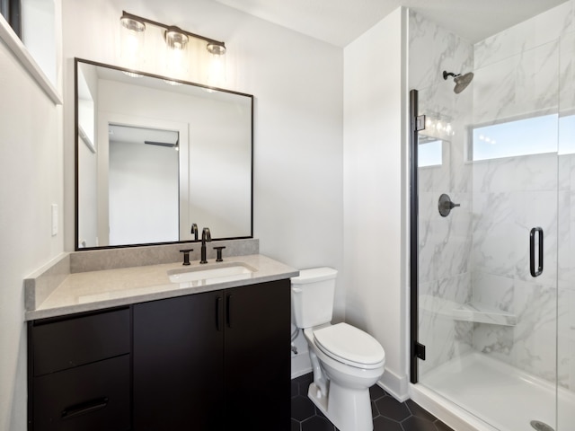 bathroom featuring tile patterned flooring, vanity, toilet, and an enclosed shower