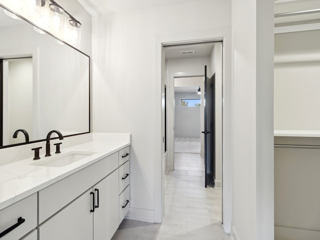 bathroom with ceiling fan and vanity