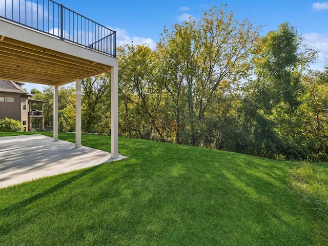 view of yard featuring a patio area and a wooden deck