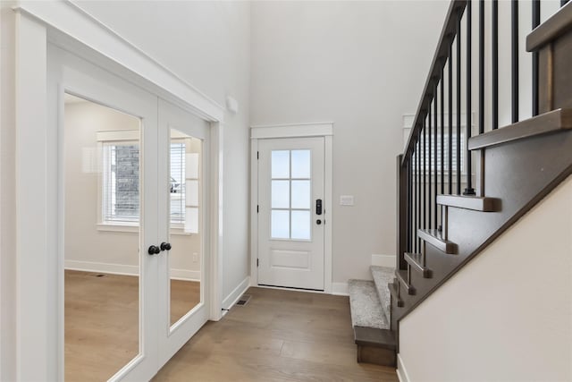 entryway featuring light hardwood / wood-style floors and french doors