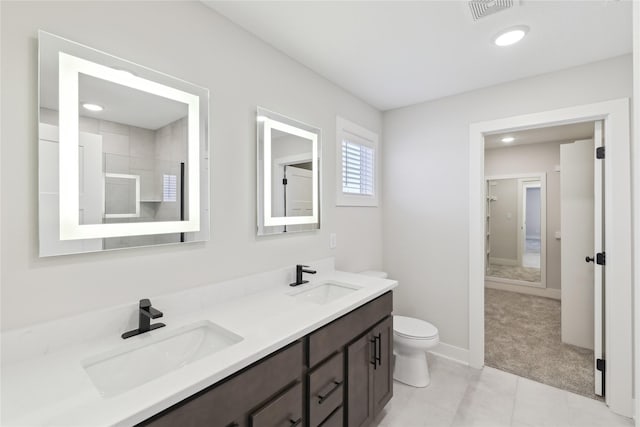 bathroom featuring tile patterned floors, vanity, and toilet