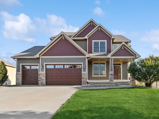 craftsman-style house featuring a front yard and a garage