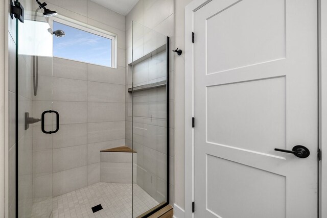 bathroom with a shower with shower door