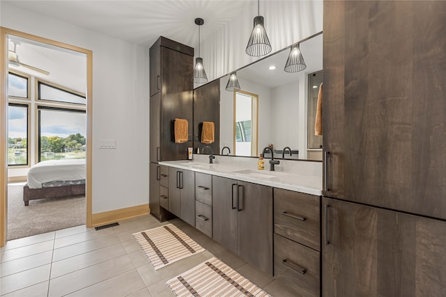 bathroom with vanity, vaulted ceiling, and tile patterned flooring