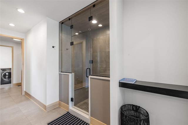 bathroom featuring washer / dryer and walk in shower