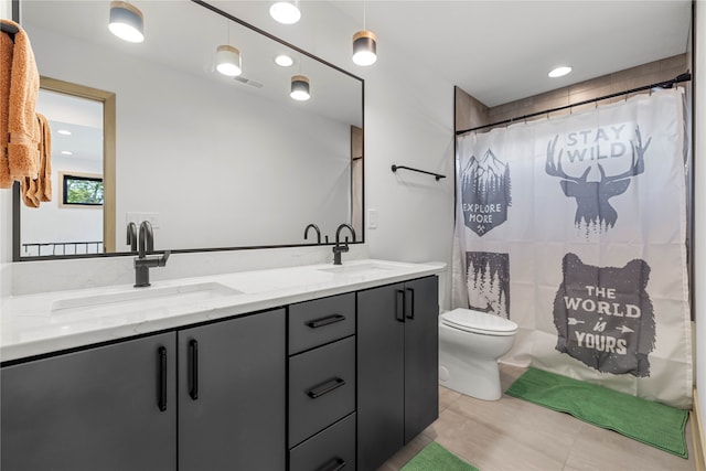 bathroom with toilet, curtained shower, vanity, and tile patterned floors