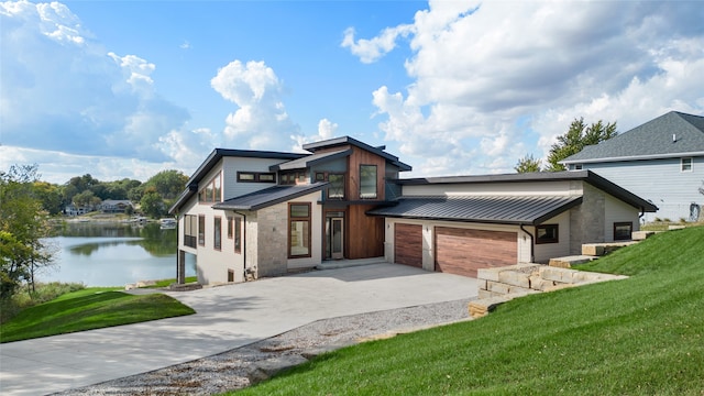 view of front of home featuring a front yard and a water view