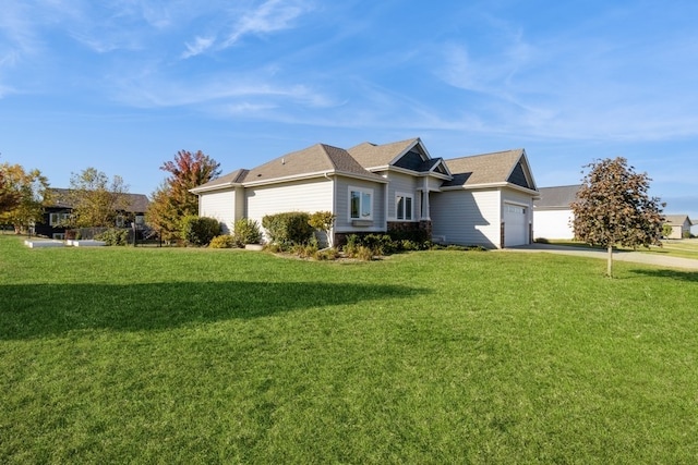 view of front of house with a front yard and a garage