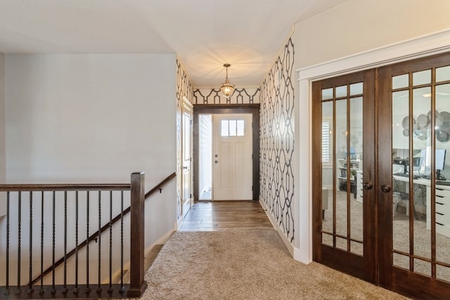 foyer entrance featuring french doors and hardwood / wood-style flooring