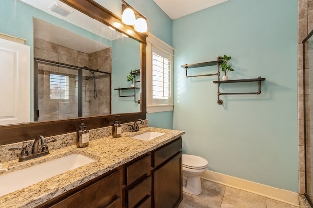 bathroom featuring toilet, walk in shower, vanity, and tile patterned flooring