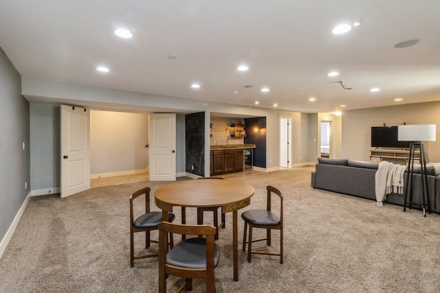 dining room featuring light carpet