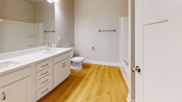 bathroom with vanity, hardwood / wood-style floors, and toilet