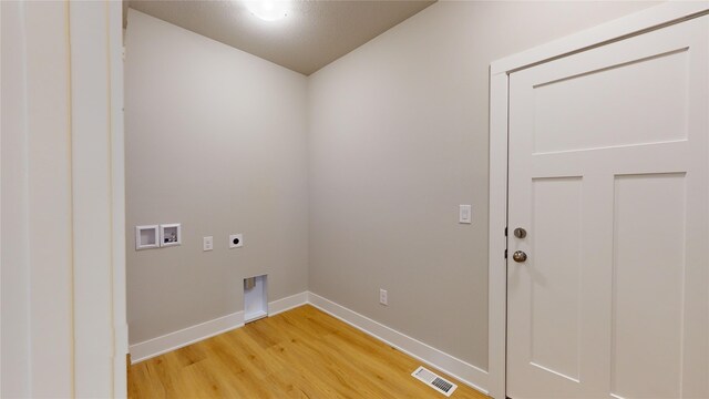 washroom with hookup for a washing machine, electric dryer hookup, and hardwood / wood-style flooring