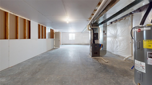 basement featuring electric water heater and heating unit