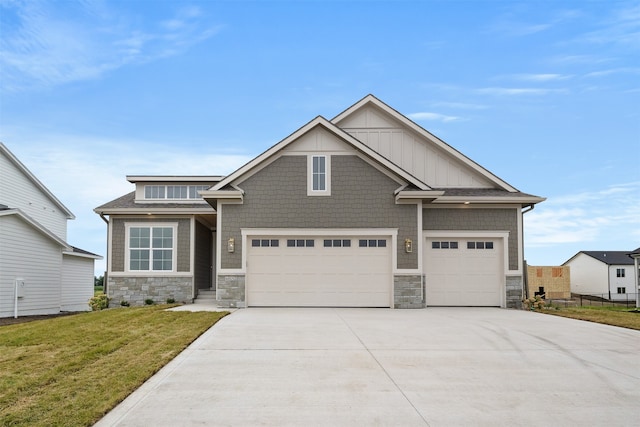 craftsman-style home with a front yard and a garage