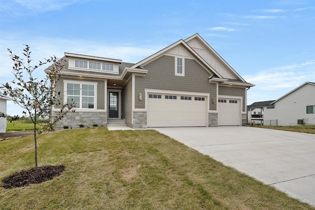 craftsman house with a front lawn and a garage