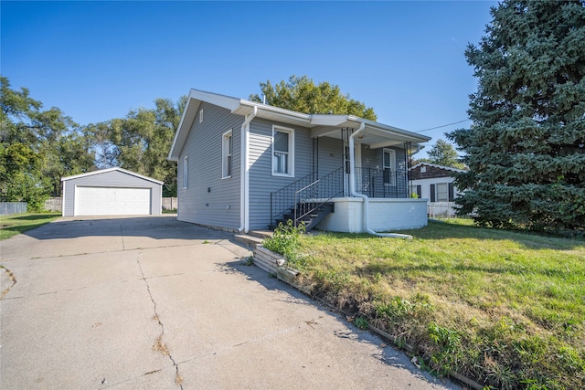 view of front of house featuring a front yard, an outbuilding, and a garage