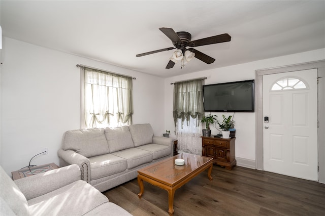 living room with ceiling fan, a healthy amount of sunlight, and dark hardwood / wood-style flooring