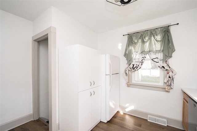 room details with hardwood / wood-style flooring and white refrigerator