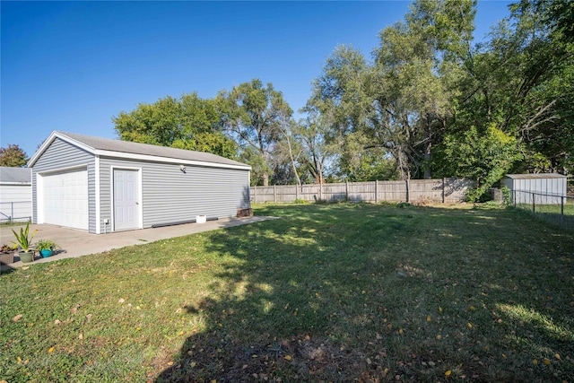 view of yard with a garage and a shed