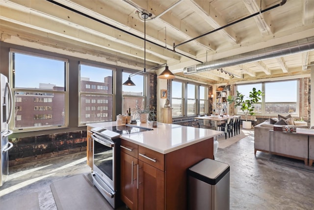 kitchen with decorative light fixtures, stainless steel electric range oven, and a kitchen island