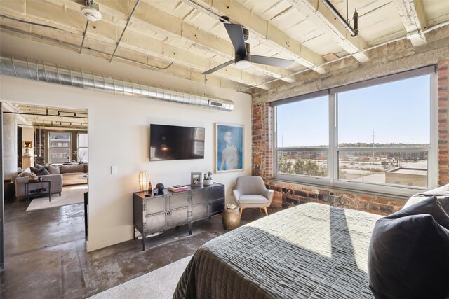 bedroom with ceiling fan and brick wall