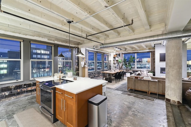 kitchen featuring open floor plan, electric stove, brown cabinetry, and unfinished concrete flooring