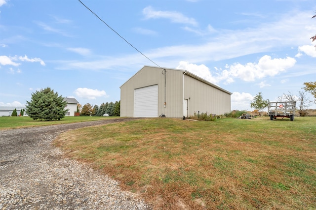 view of outbuilding featuring a yard and a garage