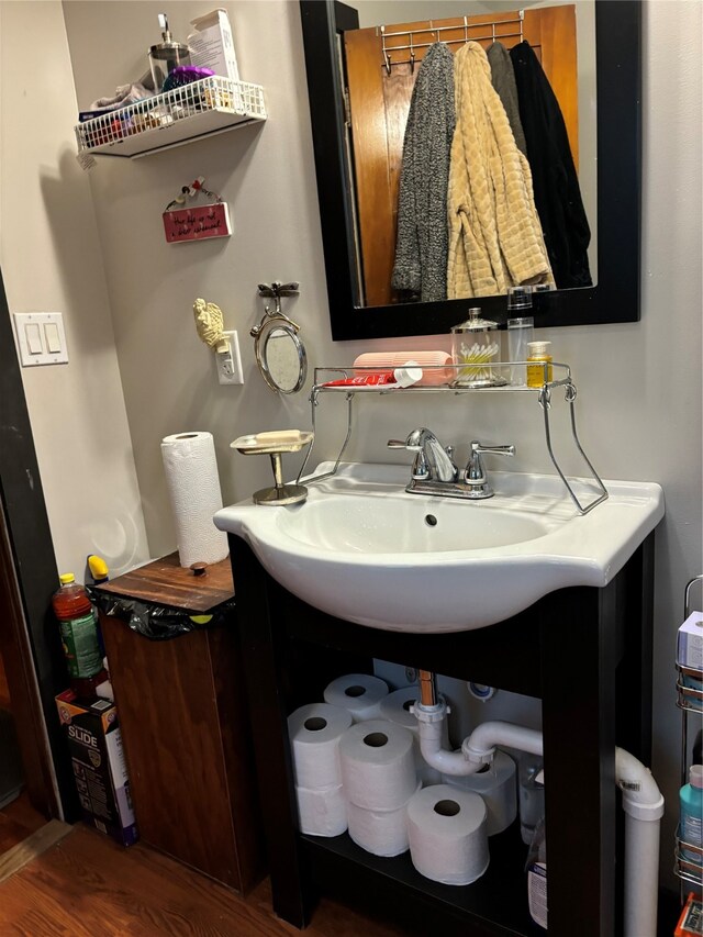 bathroom with hardwood / wood-style flooring and sink