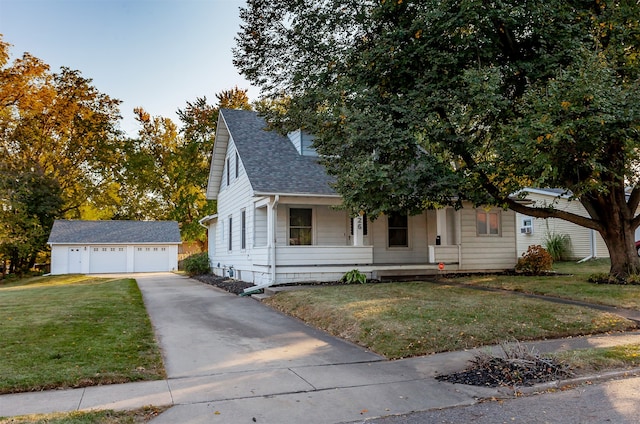 view of front of house featuring covered porch, a front lawn, an outbuilding, and a garage