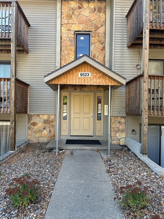 view of exterior entry with a deck