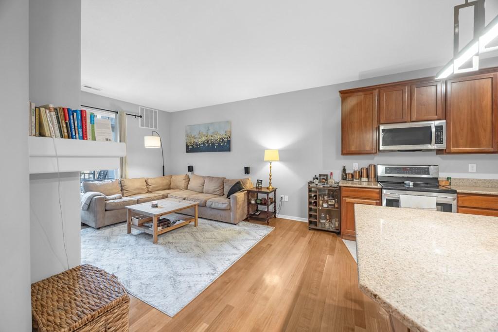 3031 Grand Ave Unit 218, Des Moines, IA 50312 - living room with light wood-style floors and baseboards