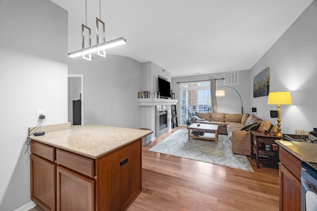 kitchen featuring light stone counters and light wood-type flooring