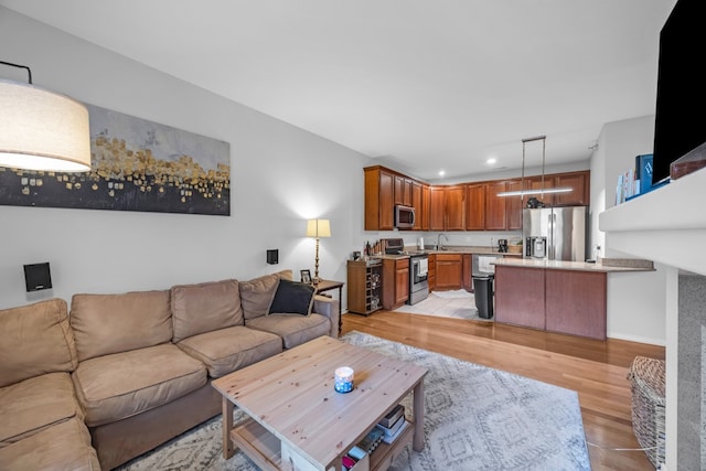 living room with sink and light wood-type flooring