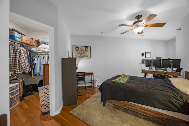 bedroom with a closet, ceiling fan, and hardwood / wood-style floors