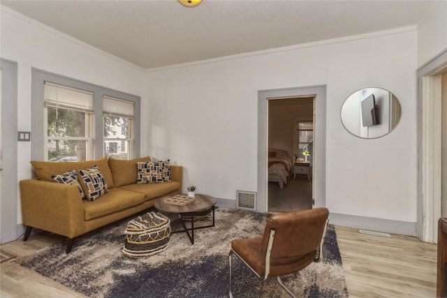 living room with ornamental molding and wood-type flooring