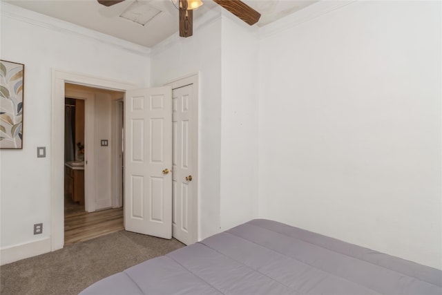 carpeted bedroom with crown molding and ceiling fan