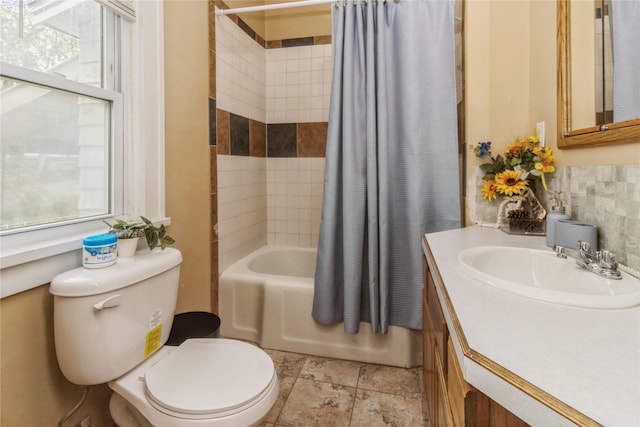 full bathroom with vanity, toilet, a healthy amount of sunlight, and shower / bathtub combination with curtain