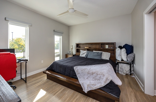 bedroom with light hardwood / wood-style flooring and ceiling fan