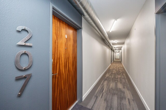 hall with dark wood-type flooring