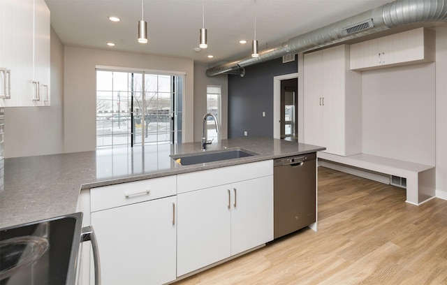 kitchen with sink, dishwasher, white cabinets, stainless steel electric range oven, and decorative light fixtures