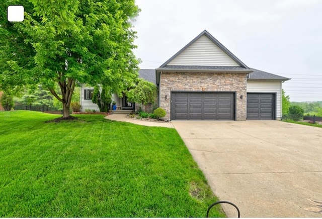 view of front of home with a garage and a front lawn