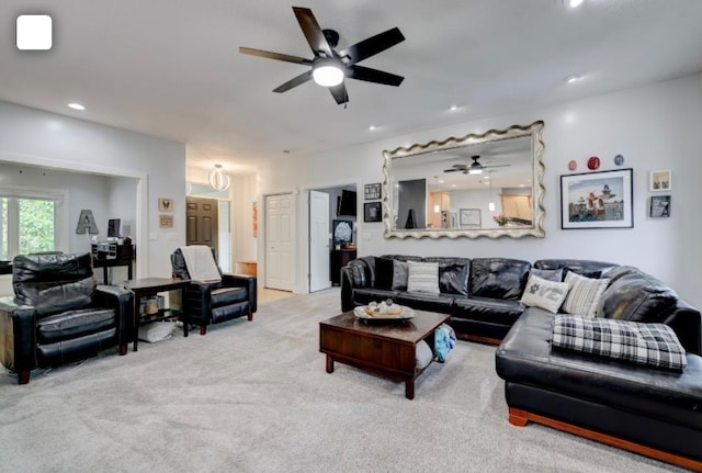 living room featuring light carpet and ceiling fan